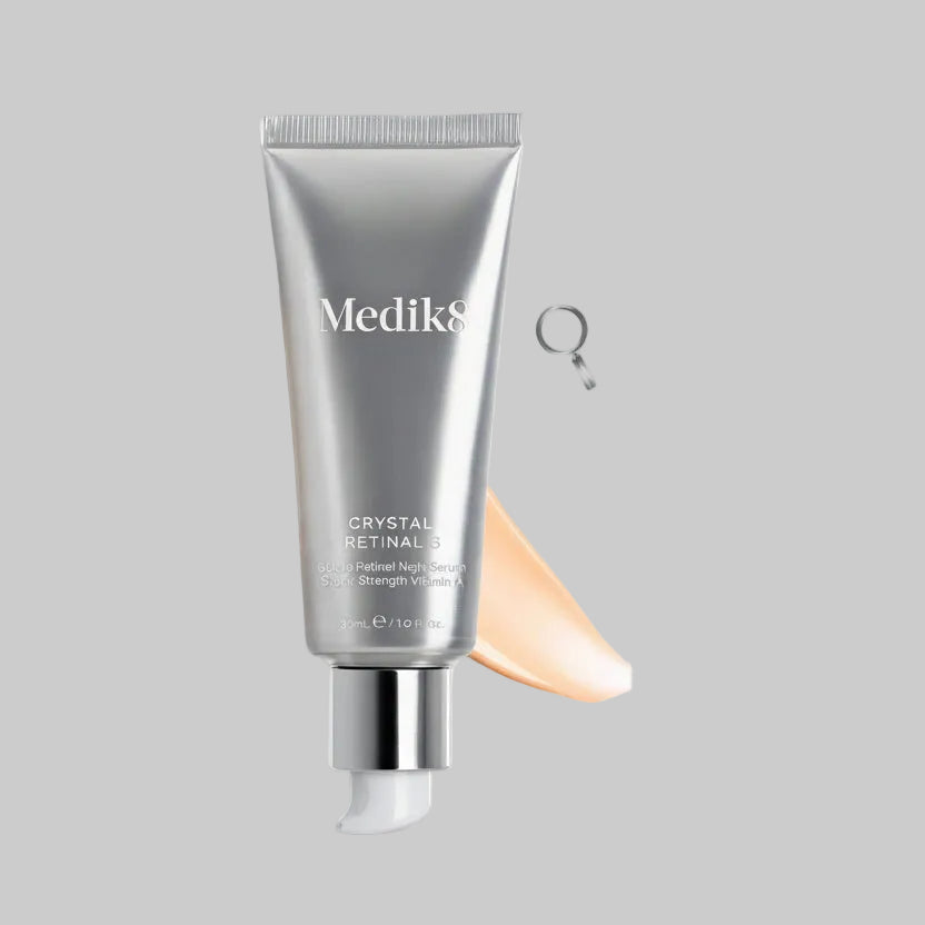 Medik8 Crystal Retinal skincare product with a swatch of cream on a white background