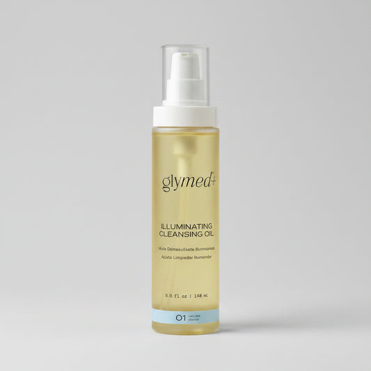 A bottle of glymed+ Illuminating Cleansing Oil on a light beige background. The bottle is filled with a pale yellow oil and features a white pump dispenser with a clear cap, and a light blue accent band at the bottom.